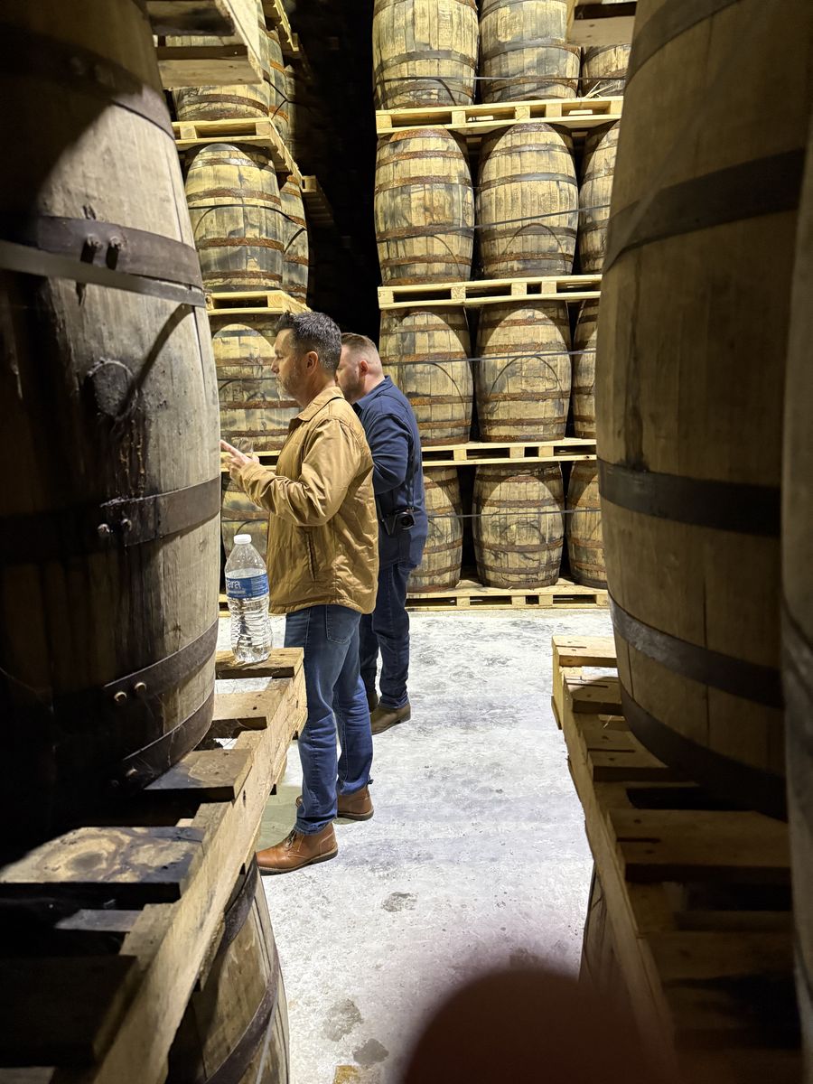 Visitors selecting barrels in a Kentucky rickhouse